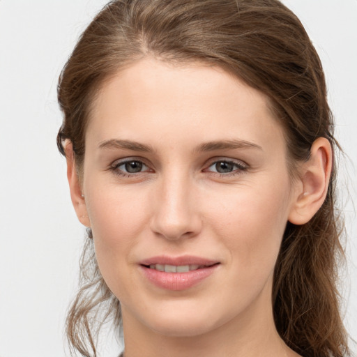 Joyful white young-adult female with long  brown hair and grey eyes