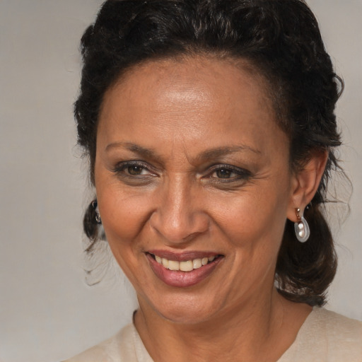 Joyful black adult female with medium  brown hair and brown eyes