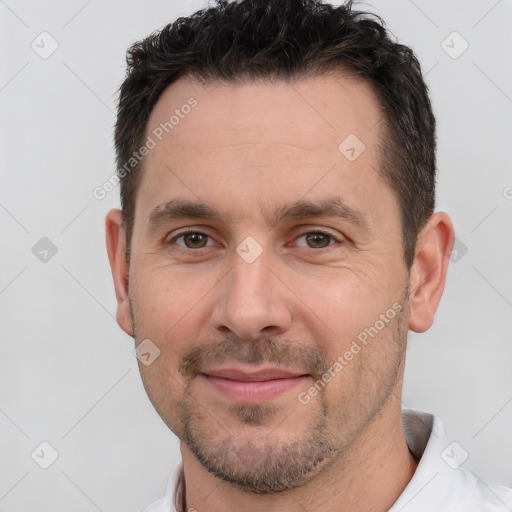 Joyful white adult male with short  brown hair and brown eyes