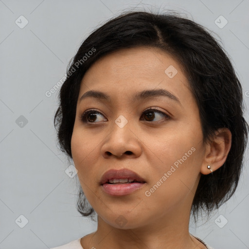 Joyful asian young-adult female with medium  black hair and brown eyes