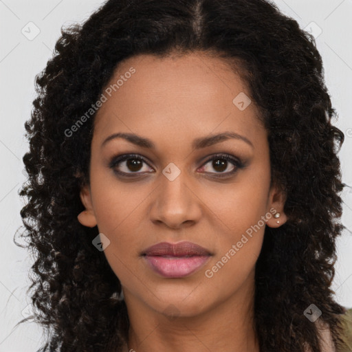 Joyful black young-adult female with long  brown hair and brown eyes