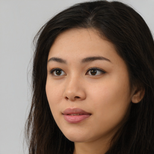Neutral latino young-adult female with long  brown hair and brown eyes