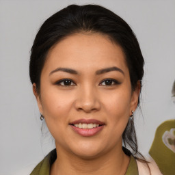 Joyful latino young-adult female with medium  brown hair and brown eyes