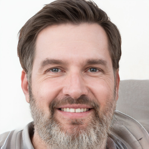 Joyful white adult male with short  brown hair and grey eyes