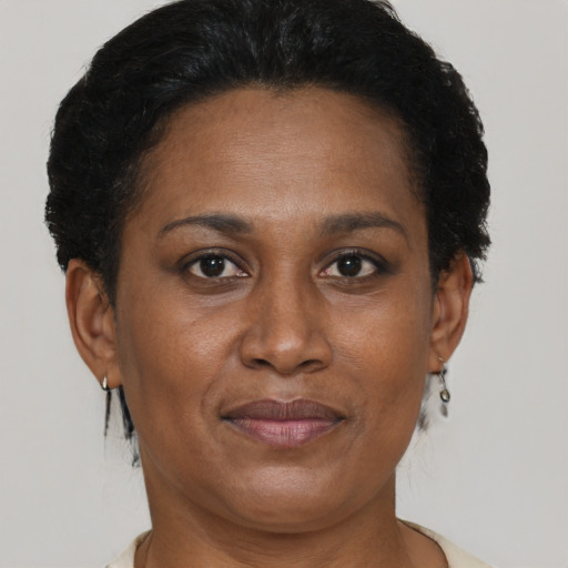 Joyful black adult female with short  brown hair and brown eyes