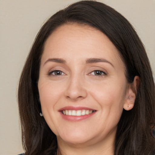 Joyful white adult female with long  brown hair and brown eyes