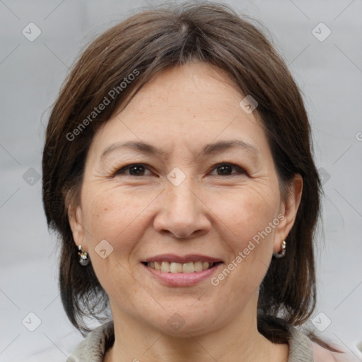 Joyful white adult female with medium  brown hair and brown eyes