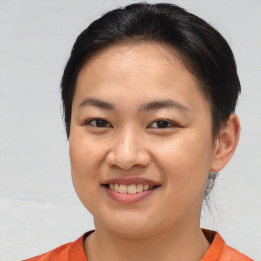 Joyful asian young-adult female with short  brown hair and brown eyes