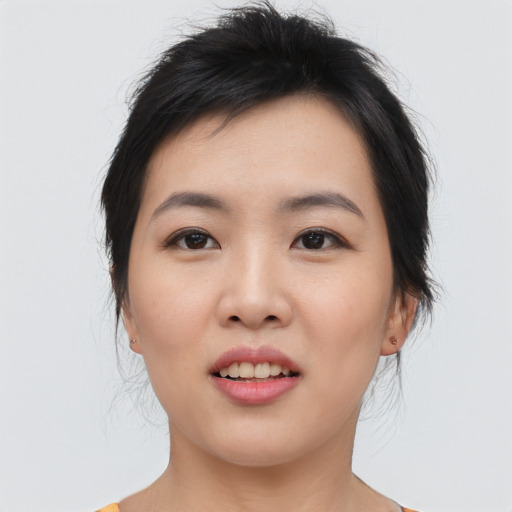 Joyful asian young-adult female with medium  black hair and brown eyes
