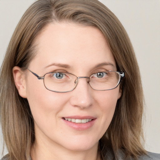 Joyful white adult female with long  brown hair and brown eyes