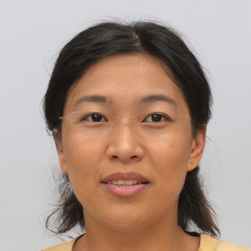 Joyful asian adult female with medium  brown hair and brown eyes