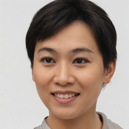 Joyful asian young-adult female with short  brown hair and brown eyes