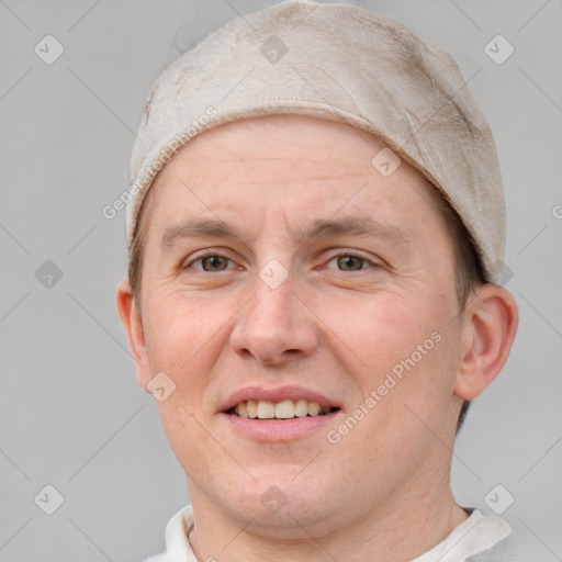 Joyful white adult male with short  brown hair and grey eyes