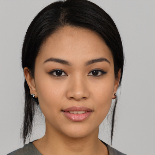 Joyful asian young-adult female with medium  black hair and brown eyes