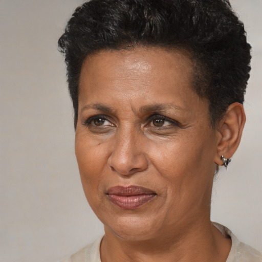 Joyful black adult female with short  brown hair and brown eyes