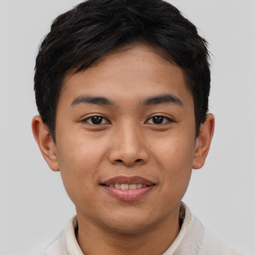 Joyful latino young-adult male with short  brown hair and brown eyes