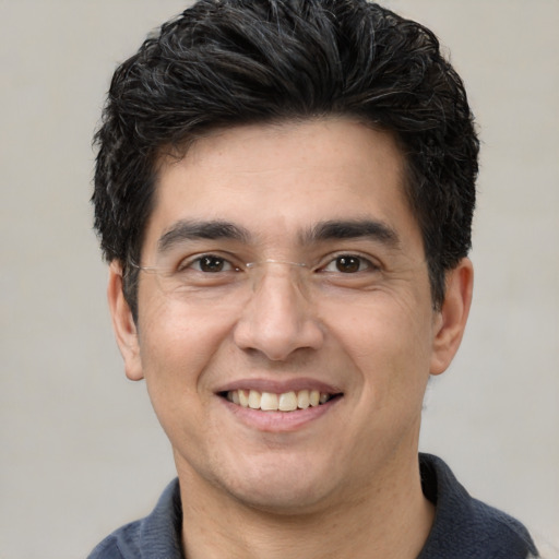 Joyful white young-adult male with short  black hair and brown eyes