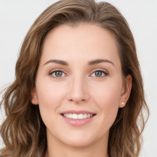 Joyful white young-adult female with long  brown hair and green eyes