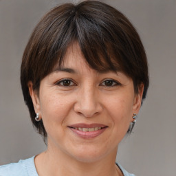 Joyful white adult female with medium  brown hair and brown eyes