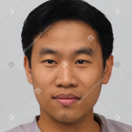 Joyful asian young-adult male with short  black hair and brown eyes