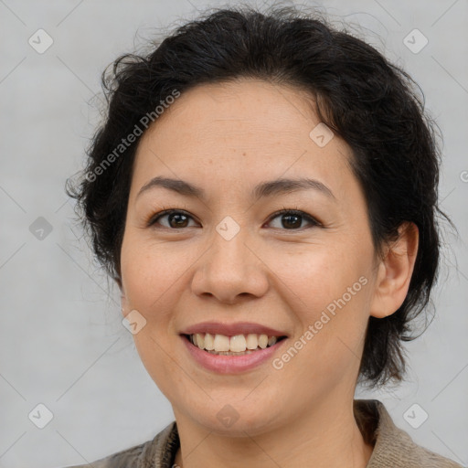 Joyful latino adult female with medium  brown hair and brown eyes