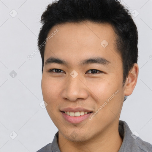 Joyful asian young-adult male with short  black hair and brown eyes