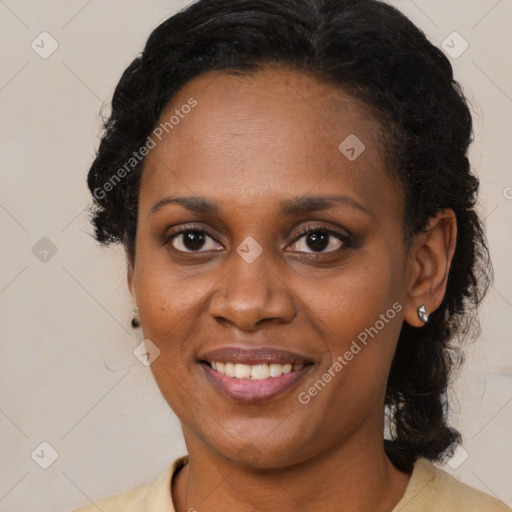 Joyful black adult female with medium  brown hair and brown eyes