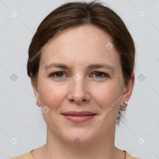 Joyful white young-adult female with short  brown hair and grey eyes