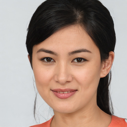 Joyful asian young-adult female with medium  brown hair and brown eyes
