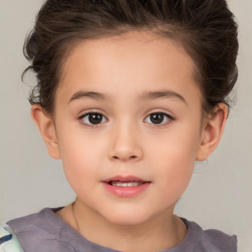 Joyful white child female with short  brown hair and brown eyes