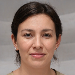 Joyful white adult female with medium  brown hair and brown eyes