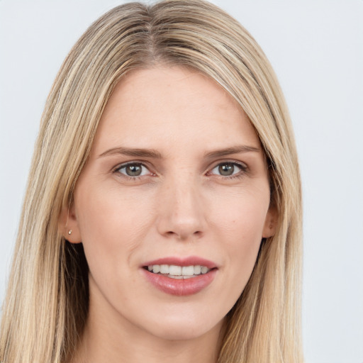 Joyful white young-adult female with long  brown hair and grey eyes