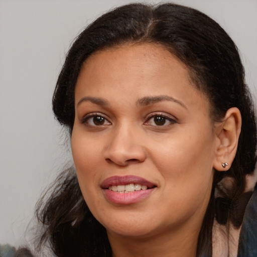 Joyful latino adult female with long  brown hair and brown eyes