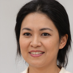 Joyful asian young-adult female with medium  brown hair and brown eyes