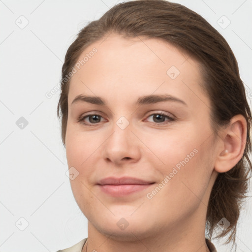 Joyful white young-adult female with medium  brown hair and grey eyes