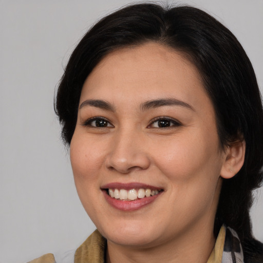 Joyful asian young-adult female with medium  brown hair and brown eyes