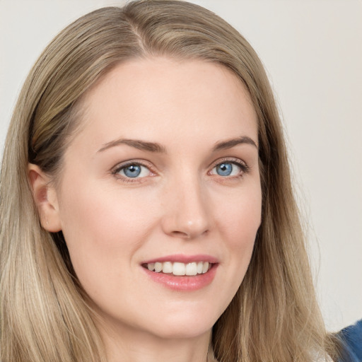 Joyful white young-adult female with long  brown hair and blue eyes