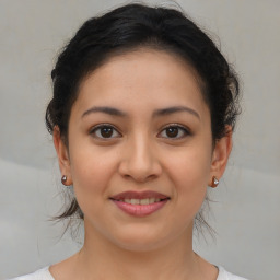 Joyful latino young-adult female with medium  brown hair and brown eyes