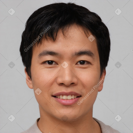 Joyful asian young-adult male with short  black hair and brown eyes