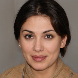 Joyful white young-adult female with medium  brown hair and brown eyes