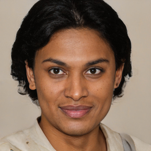 Joyful black adult female with short  brown hair and brown eyes