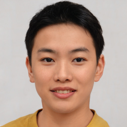 Joyful asian young-adult male with short  black hair and brown eyes