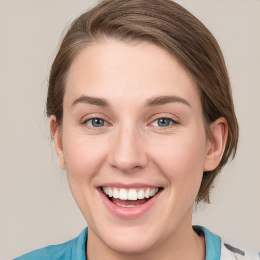 Joyful white young-adult female with medium  brown hair and blue eyes