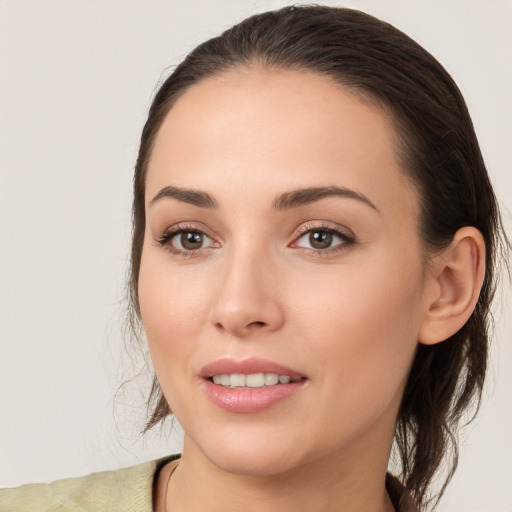 Joyful white young-adult female with medium  brown hair and brown eyes