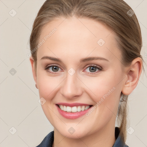 Joyful white young-adult female with medium  brown hair and blue eyes