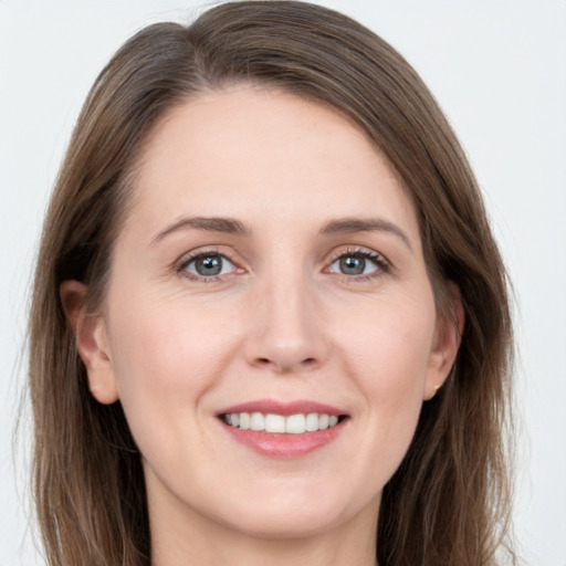 Joyful white young-adult female with long  brown hair and grey eyes