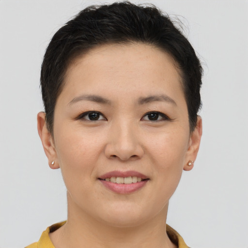 Joyful asian young-adult female with short  brown hair and brown eyes
