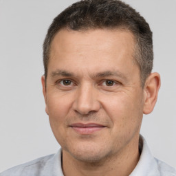 Joyful white adult male with short  brown hair and brown eyes