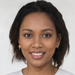 Joyful black young-adult female with medium  brown hair and brown eyes