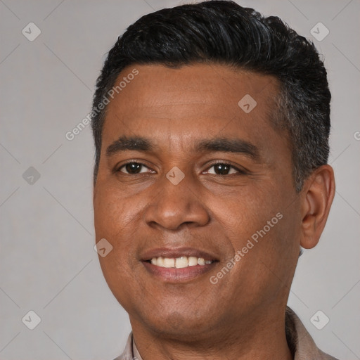 Joyful black young-adult male with short  brown hair and brown eyes